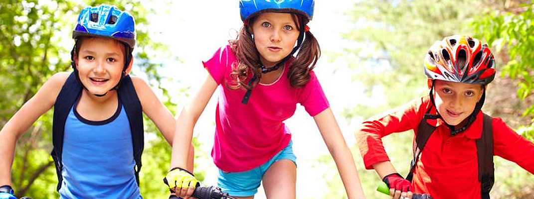 Three children riding bikes.